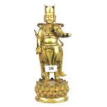 A Sino Tibetan gilt bronze figure of a standing deity on a lotus pedestal, H. 28.5cm. Condition :