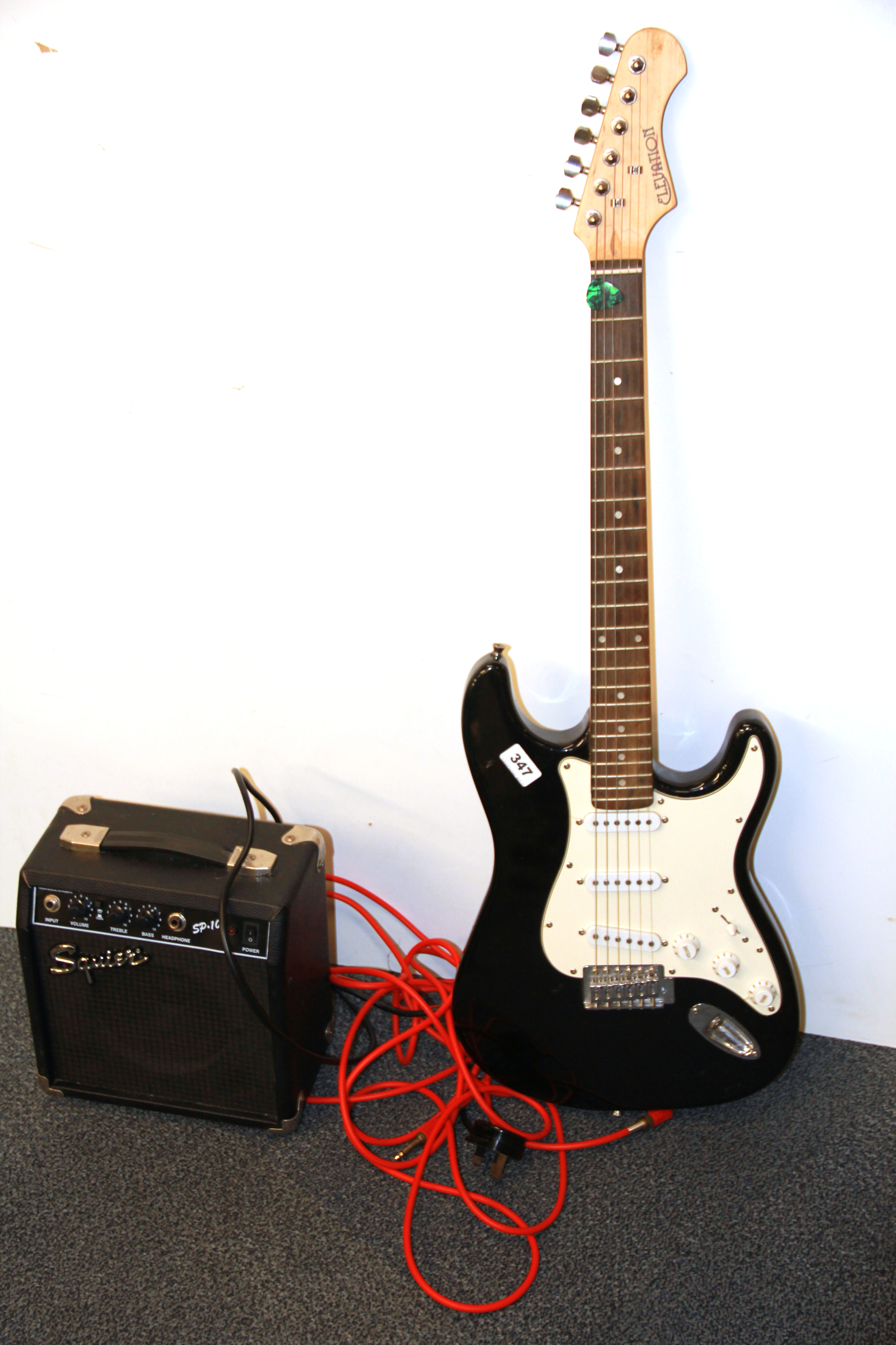 An Elevation electric guitar with a Squire amp.