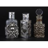 Two hallmarked silver and one 925 silver mounted perfume bottles, H. 7cm.