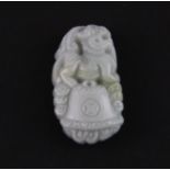 A finely carved Chinese jadeite jade amulet of a young dragon with cash, H. 4cm.