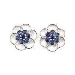 A pair of 9ct white gold flower shaped stud earrings set with sapphires, Dia. 2cm.