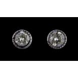 A pair of 9ct white gold (stamped 375) stud earrings set with brilliant cut diamonds.