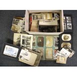 A 1920's album of postcards and photographs, together with a large quantity of vintage photographs.
