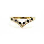 A yellow metal (tested 9ct gold) spinel and white stone set wishbone ring, (K.5).