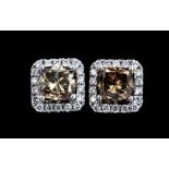 A pair of 18ct white gold (stamped 750) stud earrings set with fancy brown princess cut diamonds