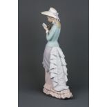 A Lladro bisque porcelain figure of a lady reading a book, H. 36cm.