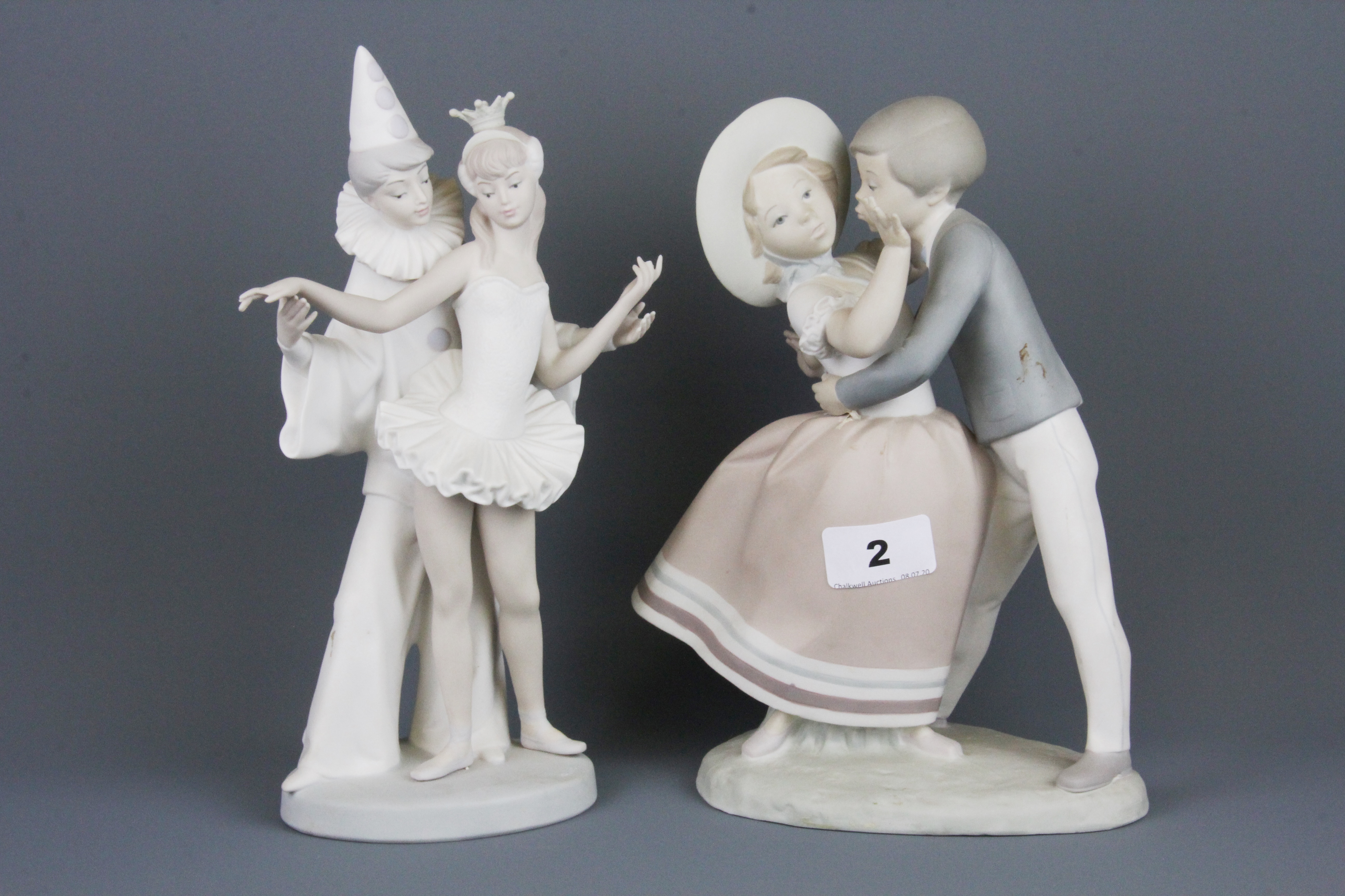 Two Lladro bisque porcelain figures of couples, H. 27, H. 25. Condition: both figures have one