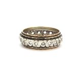 A 9ct yellow gold and silver stone set full eternity ring, (one stone missing), (R).
