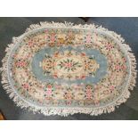 An oval Chinese washed wool rug, 200 x 145cm, together with a small washed wool rug, 150 x 60cm.