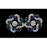 A pair of 9ct white gold earrings set with fancy blue diamonds and diamonds, L. 1.2cm.