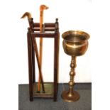 An oak stick stand with a silver mounted horn handled walking cane and a carved wooden dog head