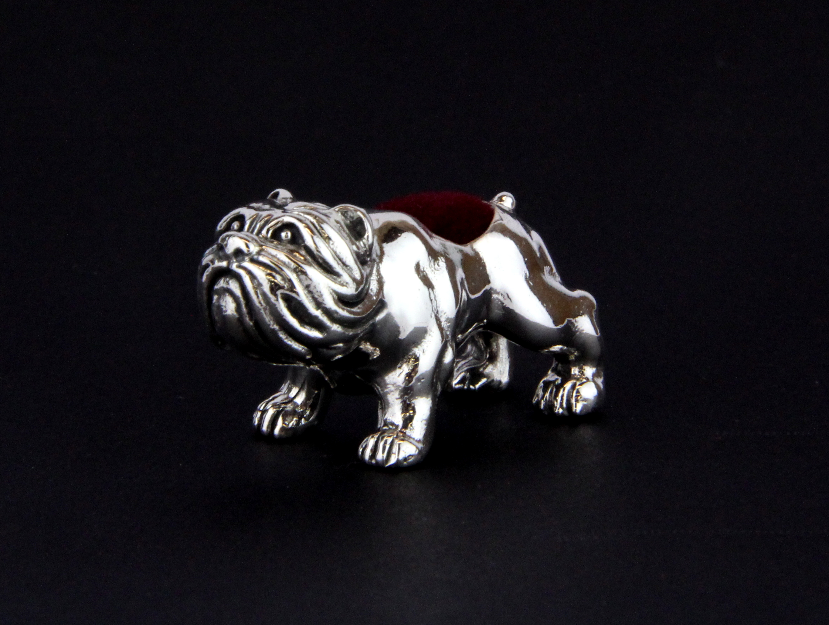 A small sterling silver bulldog pin cushion, L. 3.5cm H. 2cm.