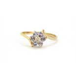 A 9ct yellow gold tanzanite and diamond set cluster ring, (M).