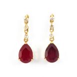 A pair of 18ct yellow gold pear cut ruby and diamond set drop earrings, L. 1.6cm.