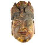 A Chinese carved and painted wooden mask of the goddess Guanyin, H. 38cm. Condition: overall