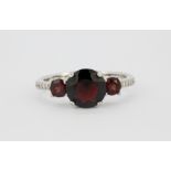 A 925 silver garnet set ring, (O.5).