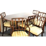 A Regency style mahogany extending dining table and six chairs.