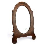 An unusual William IV walnut veneered free standing mirror with scalloped edged glass, H. 54cm.