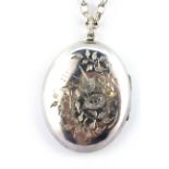 A white metal (tested silver) locket pendant and chain.