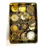 A tin of pocket watch movements.