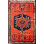 A hand woven red ground Eastern wool rug, 190 x 130cm.