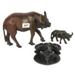 Three carved wooden figures of water buffalo, tallest H. 17cm.