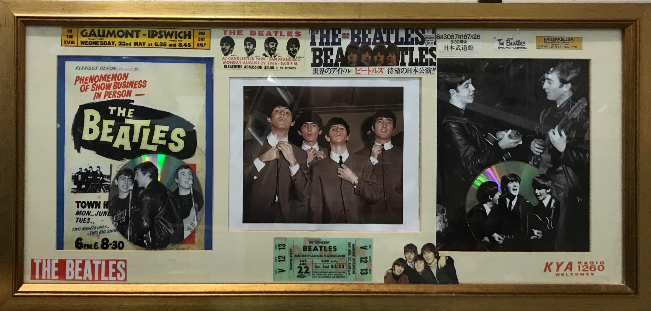 A framed collage of Beatles memorabilia, mostly reproduced items.