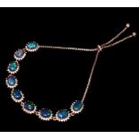 A 925 silver rose gold gilt adjustable bracelet set with cabochon cut black opals and white stones.