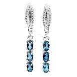 A pair of 925 silver drop earrings set with oval cut London blue topaz, L. 3cm.