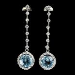 A pair of 925 silver drop earrings set with round cut blue topaz surrounded by white stones, L. 4.