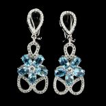 A pair of 925 silver flower shaped drop earrings set with oval cut blue topaz and white stones, L.