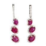 A pair of 925 silver drop earrings set with oval cut rubies and white stones, L. 4.2cm.