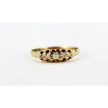 An 18ct yellow gold ring set with five graduated old cut diamonds, (N.5).