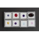 Eight individually boxed unmounted gemstones, including garnet, amethyst, sapphire, citrine, etc.