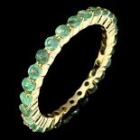 A 925 silver gilt full eternity ring set with emeralds, (P.5).
