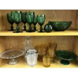 A group of pressed green and other glass items.