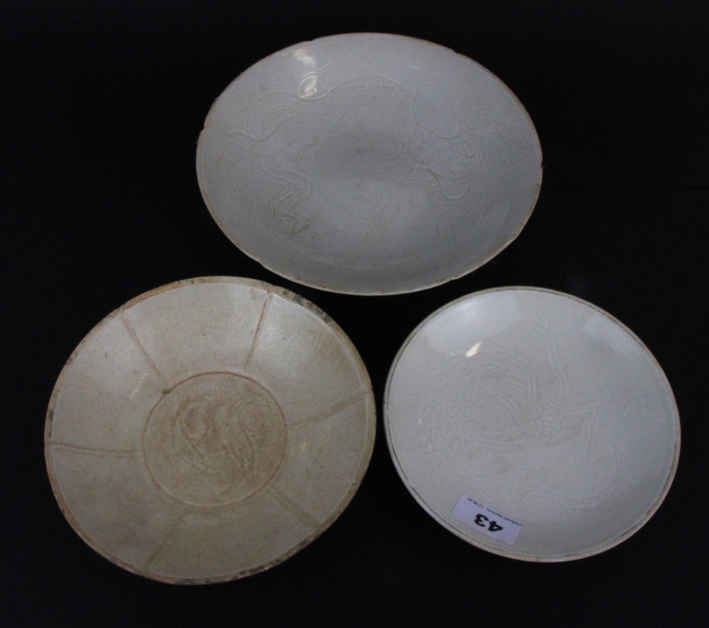 Three Chinese Song dynasty style incised porcelain plates.