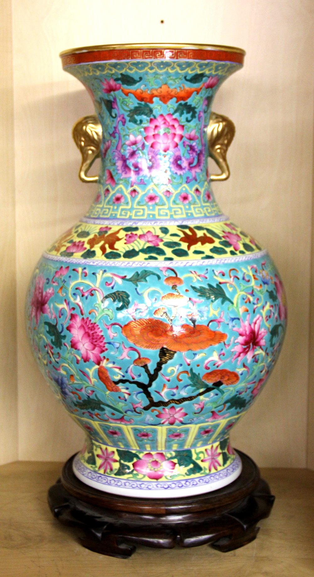 A large Chinese hand painted porcelain vase with exquisite decoration and elephant head handles on a