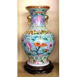 A large Chinese hand painted porcelain vase with exquisite decoration and elephant head handles on a