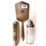 A hallmarked silver topped sugar shaker, silver backed mirror and brush.