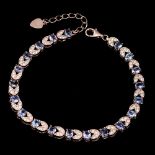 A 925 silver rose gold gilt bracelet set with tanzanites and white stones, L. 20cm.