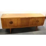 A 1970's teak sideboard with fold out centre cocktail bar, W. 183cm.