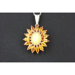 A 925 silver pendant and chain set with a cabochon cut opal and marquise cut orange topaz, L. 2.