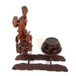 A Chinese carved wooden figure of a lady carrying a jar, H. 42cm, together with three Chinese carved