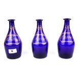Three early 19th Century gilt blue glass decanters, H. 19cm.
