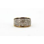 A 9ct yellow and white gold diamond pave set ring, (P).