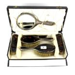 A boxed hallmarked silver and tortoise shell vanity set, London c.1922.