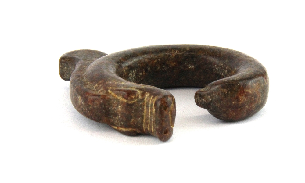 A Chinese carved brown jade archaic form dragon amulet, H. 6.5cm.