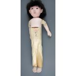 A mid 20th Century oriental porcelain and cloth doll with movable arms and legs, H. 49cm.