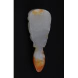 An unusual Chinese carved white and russet jade head amulet, H. 8.7cm.